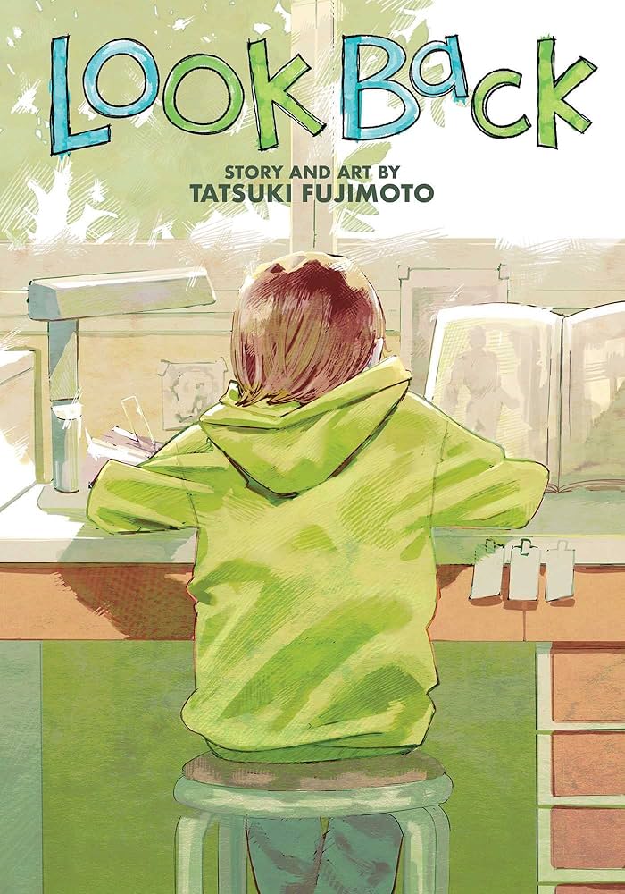 A highschool girl in a green hoodie sits at her desk facing away while hunched over a book.