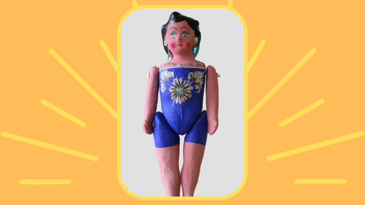 Orange background with yellow rays and a paper mache doll in the center