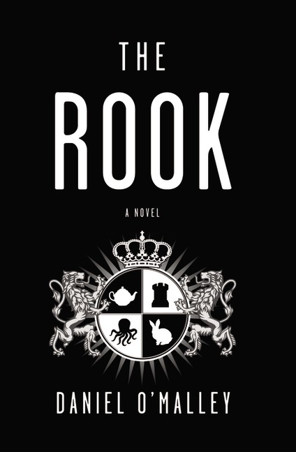 Black cover with white and black royal insignia showing a teapot, rook, octopus, and rabbit.