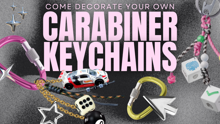 Come decorate your own carabiner keychain. Charcol textured background with chrome stars and mouse arrow. Pink carabiner with bulky keychain made of dice, a toy car, and a magic 8 ball. Second keychain made of paracord and tiles with fingerprint, checkmark, and house icons on them.